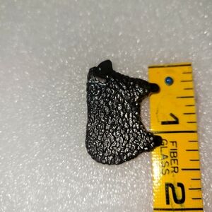 Textured Black Sheep lapel pin.